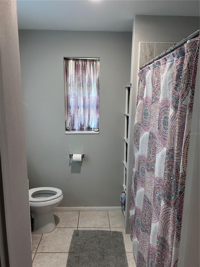 808 Hillsdale Dr, Cocoa, FL 32922 - bathroom featuring tile patterned flooring, toilet, a shower with shower curtain, and baseboards