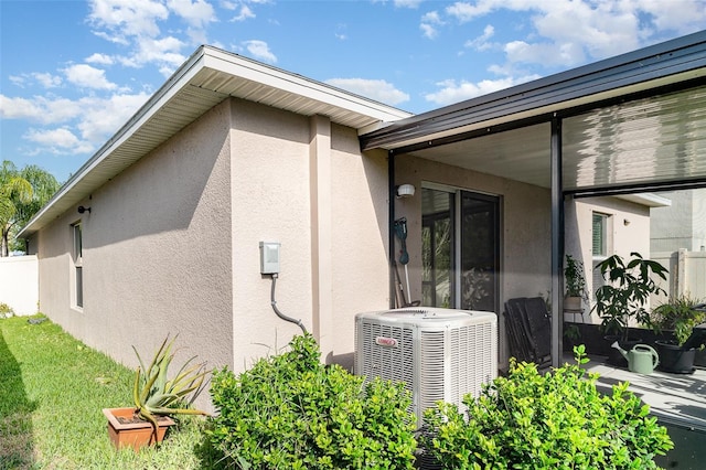17334 White Mangrove Dr, Wimauma, FL 33598 - view of property exterior featuring stucco siding and cooling unit
