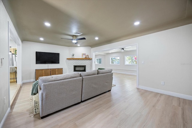 6875 11th Ave N, Saint Petersburg, FL 33710 - living area featuring a ceiling fan, light wood-style flooring, a fireplace, baseboards, and recessed lighting