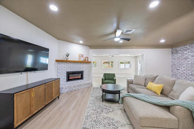 6875 11th Ave N, Saint Petersburg, FL 33710 - living area featuring light wood-style flooring, a brick fireplace, recessed lighting, and a ceiling fan