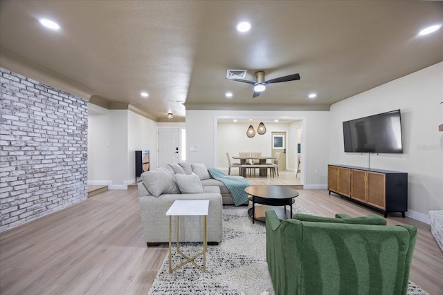 6875 11th Ave N, Saint Petersburg, FL 33710 - living area with a ceiling fan, light wood finished floors, baseboards, recessed lighting, and brick wall