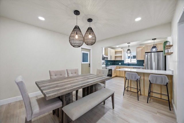 6875 11th Ave N, Saint Petersburg, FL 33710 - dining room featuring light wood-type flooring, recessed lighting, and baseboards