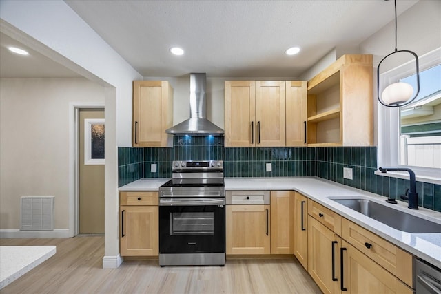 6875 11th Ave N, Saint Petersburg, FL 33710 - kitchen with stainless steel electric range, wall chimney range hood, light brown cabinetry, a sink, and recessed lighting