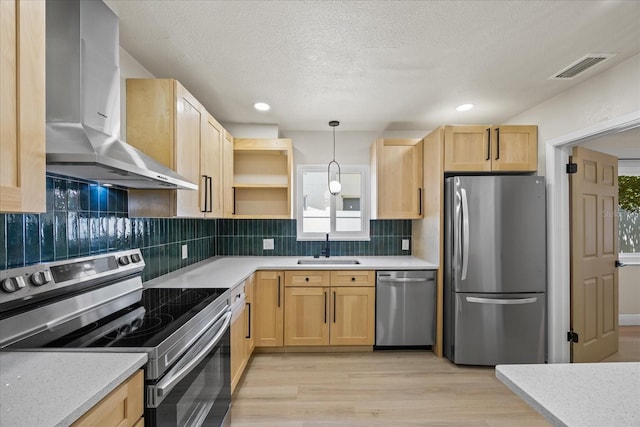 6875 11th Ave N, Saint Petersburg, FL 33710 - kitchen featuring appliances with stainless steel finishes, extractor fan, a sink, light brown cabinets, and a textured ceiling