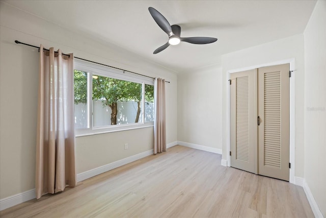 6875 11th Ave N, Saint Petersburg, FL 33710 - unfurnished bedroom with wood finished floors, a ceiling fan, a closet, and baseboards