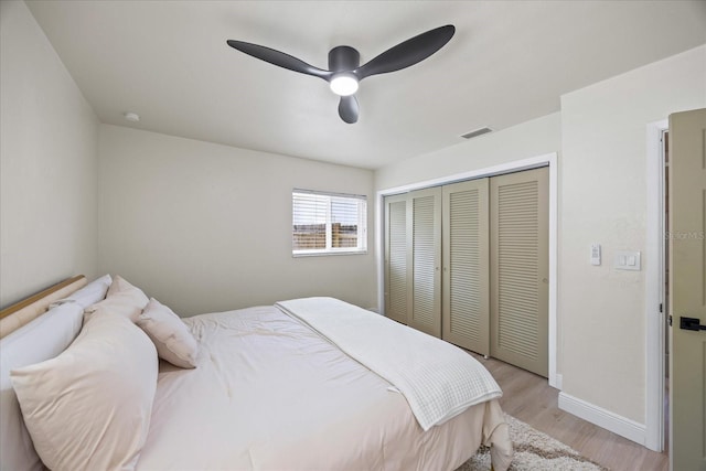 6875 11th Ave N, Saint Petersburg, FL 33710 - bedroom with light wood-style floors, a closet, baseboards, and ceiling fan