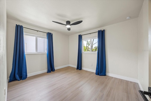6875 11th Ave N, Saint Petersburg, FL 33710 - unfurnished room with wood finished floors, a ceiling fan, baseboards, and a smoke detector