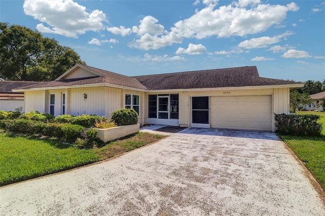 3053 Gregor Ct, Palm Harbor, FL 34684 - ranch-style home with an attached garage, concrete driveway, and a front yard