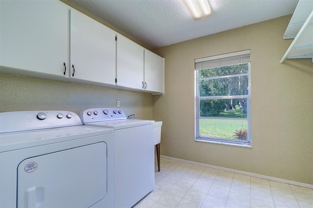 3053 Gregor Ct, Palm Harbor, FL 34684 - laundry area featuring cabinet space, washing machine and dryer, baseboards, light floors, and a textured ceiling
