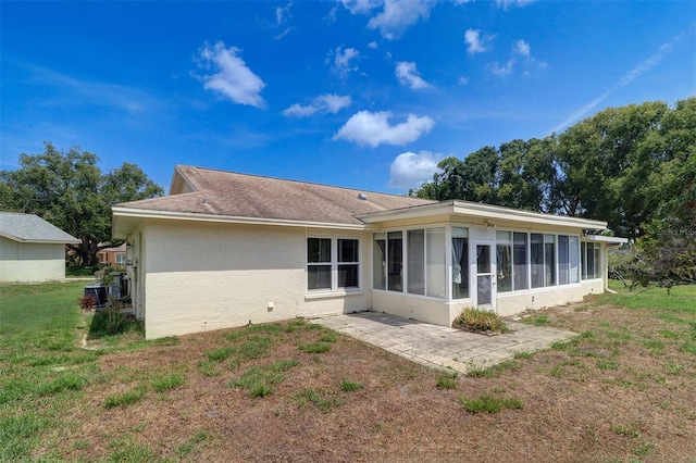 3053 Gregor Ct, Palm Harbor, FL 34684 - rear view of house with a sunroom, stucco siding, a patio, a lawn, and cooling unit