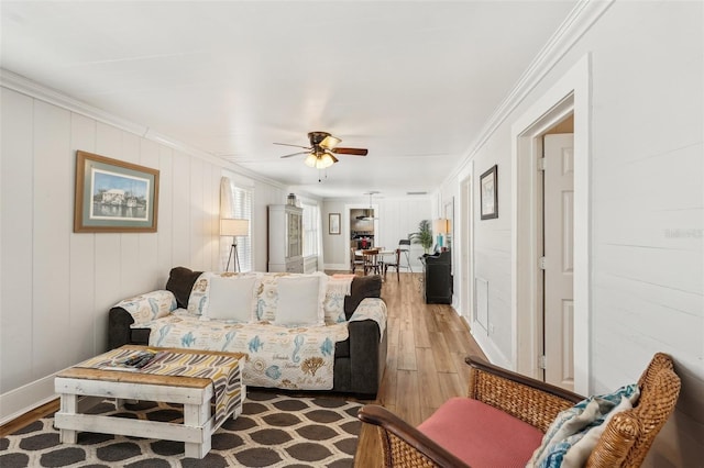 2245 Bahia Vista St, Sarasota, FL 34239 - living area with wood finished floors, ornamental molding, a ceiling fan, a decorative wall, and baseboards