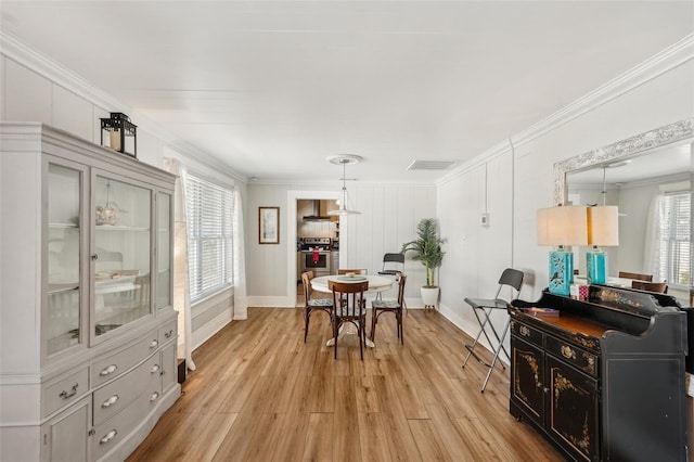 2245 Bahia Vista St, Sarasota, FL 34239 - dining space featuring ornamental molding, baseboards, and light wood finished floors