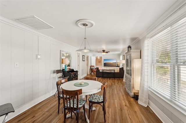 2245 Bahia Vista St, Sarasota, FL 34239 - dining space with light wood-type flooring, a ceiling fan, and ornamental molding