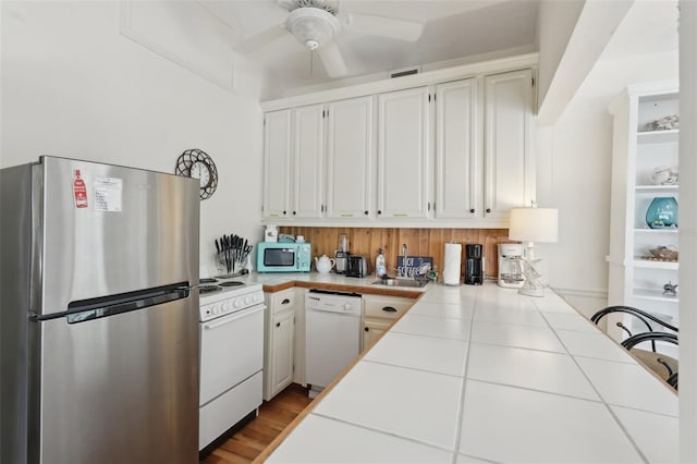 2245 Bahia Vista St, Sarasota, FL 34239 - kitchen featuring white appliances, tile counters, a ceiling fan, and white cabinetry