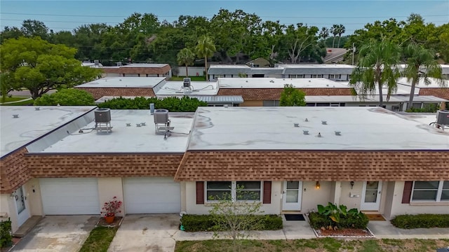 602 Mindy Dr, Largo, FL 33771 - view of front facade with a garage, a shingled roof, and mansard roof