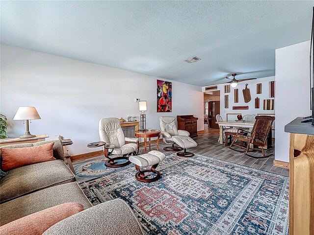 602 Mindy Dr, Largo, FL 33771 - living area featuring a ceiling fan, wood finished floors, baseboards, and a textured ceiling