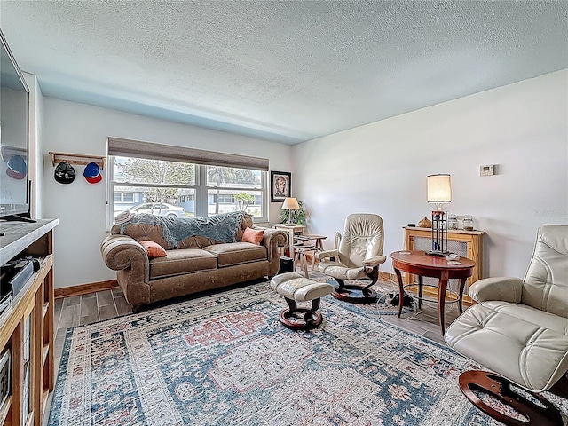 602 Mindy Dr, Largo, FL 33771 - living room with wood finished floors, a textured ceiling, and baseboards