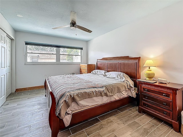602 Mindy Dr, Largo, FL 33771 - bedroom with wood tiled floors, a closet, a ceiling fan, and baseboards