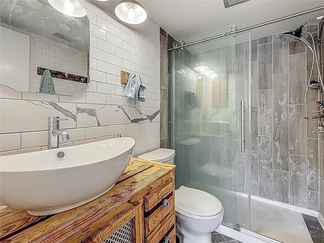 602 Mindy Dr, Largo, FL 33771 - bathroom featuring tile walls, toilet, a shower stall, and vanity