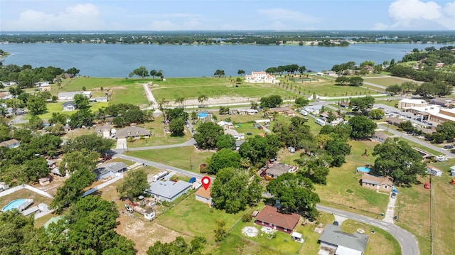 aerial view of property and surrounding area with a nearby body of water
