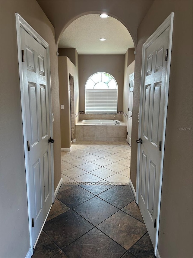 13632 Deventer Ct, Hudson, FL 34667 - bathroom with a bath, baseboards, and recessed lighting