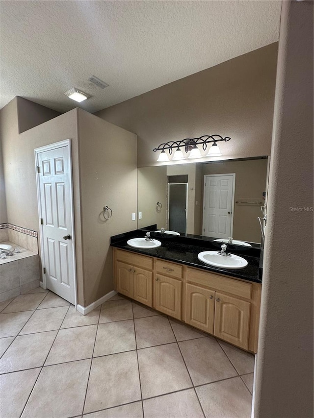 13632 Deventer Ct, Hudson, FL 34667 - bathroom featuring a textured ceiling, tile patterned flooring, double vanity, a shower stall, and a garden tub