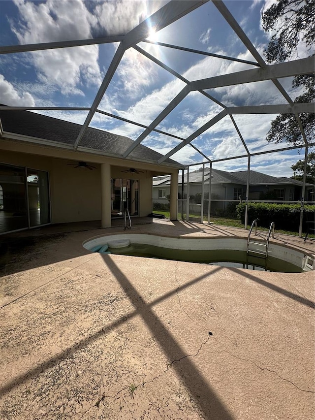 13632 Deventer Ct, Hudson, FL 34667 - back of house with a ceiling fan, a patio area, glass enclosure, and stucco siding