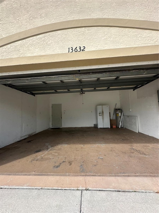 13632 Deventer Ct, Hudson, FL 34667 - garage featuring white refrigerator with ice dispenser