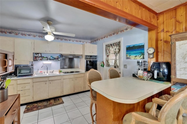 3626 S Hesperides St, Tampa, FL 33629 - kitchen featuring black oven, a sink, stainless steel microwave, light countertops, and a peninsula