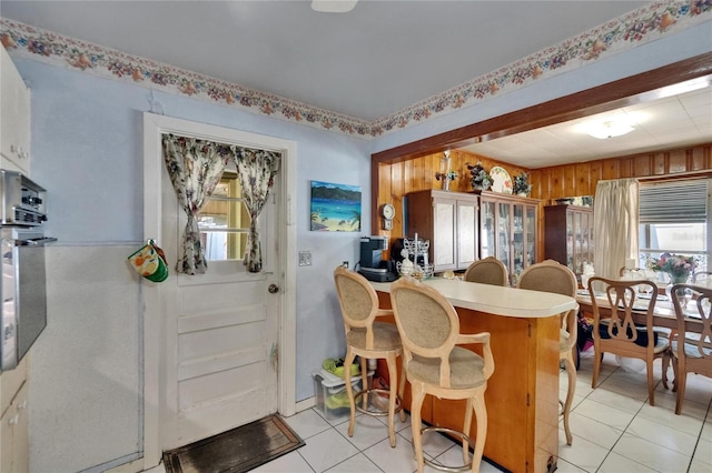 3626 S Hesperides St, Tampa, FL 33629 - kitchen with light tile patterned floors, healthy amount of natural light, a kitchen breakfast bar, and oven