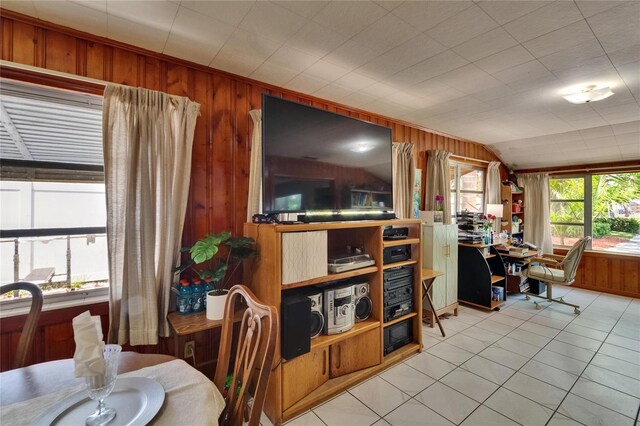 3626 S Hesperides St, Tampa, FL 33629 - dining area with wooden walls, a desk, light tile patterned floors, and lofted ceiling