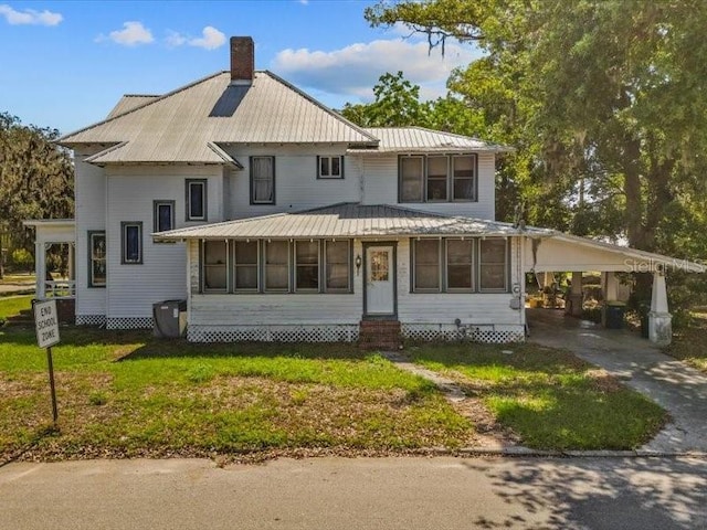 485 E Stanford St, Bartow, FL 33830 - view of front facade with entry steps, a carport, a chimney, concrete driveway, and metal roof