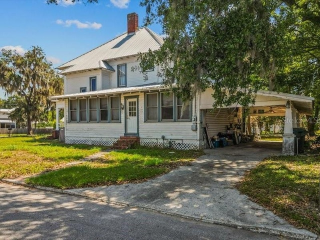 485 E Stanford St, Bartow, FL 33830 - view of front of home with entry steps, a front yard, concrete driveway, a chimney, and a carport