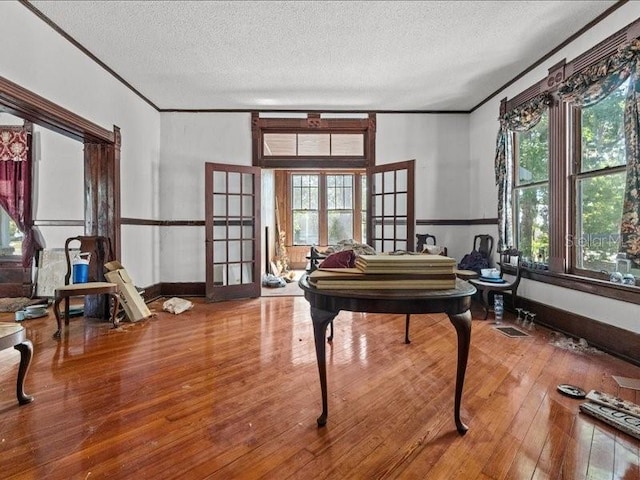 485 E Stanford St, Bartow, FL 33830 - living area featuring french doors, hardwood / wood-style flooring, a textured ceiling, crown molding, and baseboards