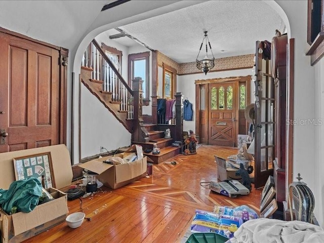 485 E Stanford St, Bartow, FL 33830 - foyer entrance featuring plenty of natural light, stairway, parquet floors, and arched walkways