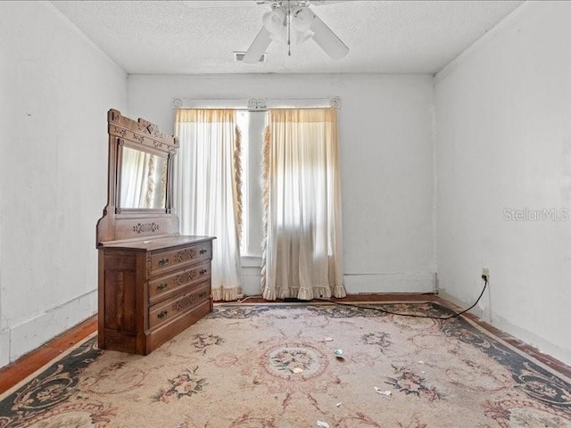 485 E Stanford St, Bartow, FL 33830 - unfurnished bedroom with a textured ceiling, ceiling fan, and wood finished floors