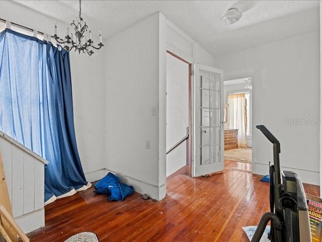 485 E Stanford St, Bartow, FL 33830 - exercise area with a chandelier, hardwood / wood-style floors, and a textured ceiling