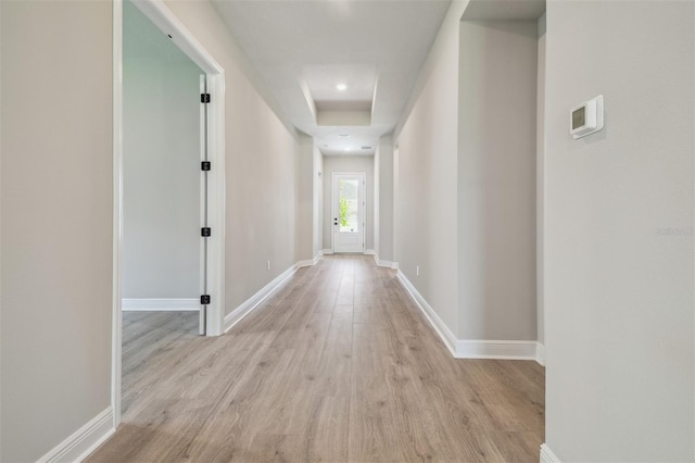 corridor with wood finished floors, baseboards, and recessed lighting
