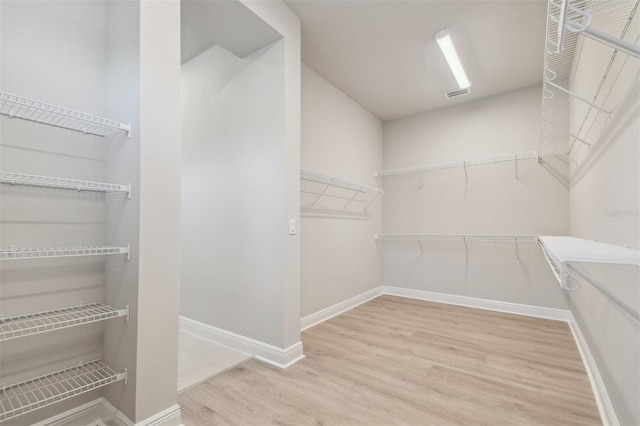 walk in closet featuring wood finished floors
