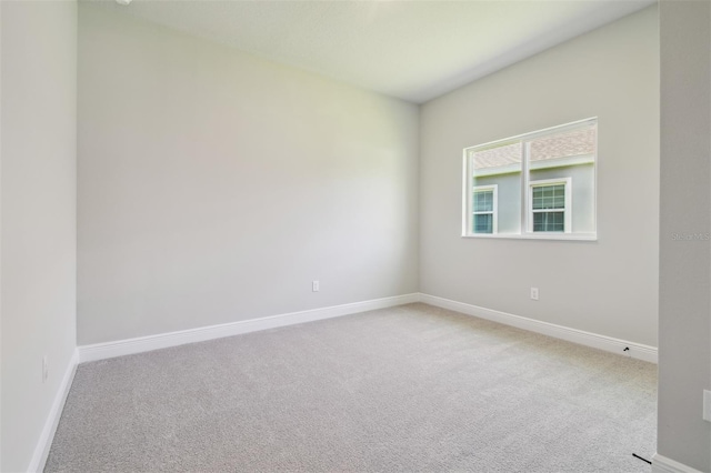 spare room with carpet floors and baseboards