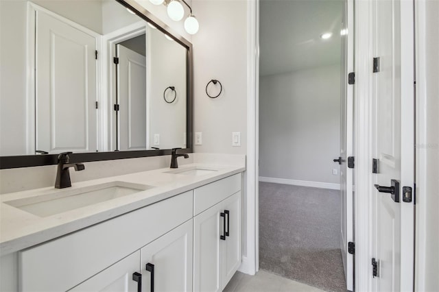 full bathroom featuring double vanity and baseboards