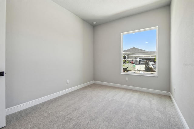 spare room with carpet floors and baseboards