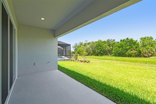 view of grassy yard with a patio and a lanai