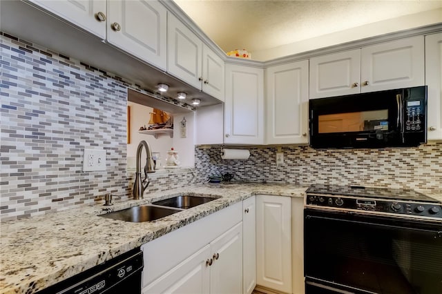 7465 Bay Island Dr S Unit 213, South Pasadena, FL 33707 - kitchen featuring black appliances, a sink, decorative backsplash, white cabinetry, and light stone countertops
