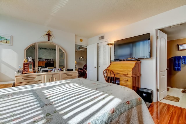 7465 Bay Island Dr S Unit 213, South Pasadena, FL 33707 - bedroom featuring wood finished floors and a closet