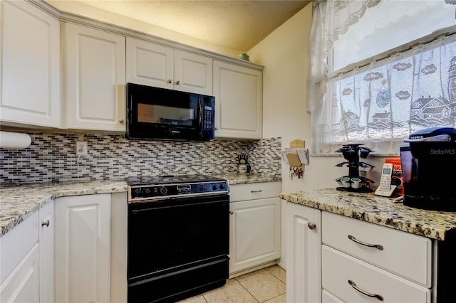 7465 Bay Island Dr S Unit 213, South Pasadena, FL 33707 - kitchen with black appliances, tasteful backsplash, light tile patterned flooring, and light stone countertops