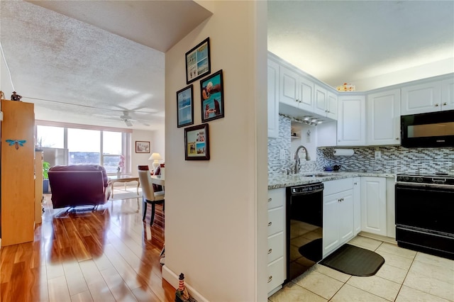7465 Bay Island Dr S Unit 213, South Pasadena, FL 33707 - kitchen featuring black appliances, ceiling fan, decorative backsplash, a sink, and light stone countertops