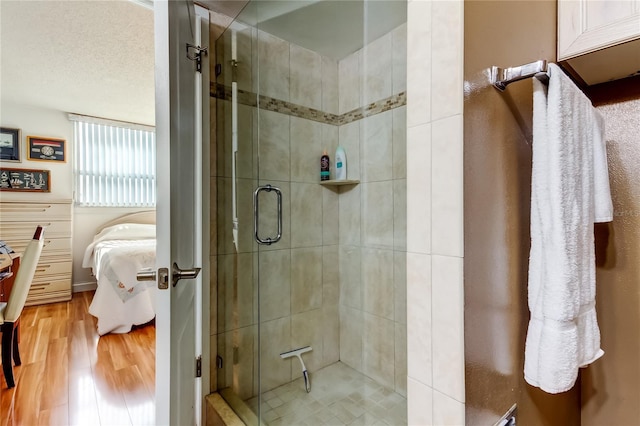 7465 Bay Island Dr S Unit 213, South Pasadena, FL 33707 - full bathroom featuring ensuite bathroom, a stall shower, and wood finished floors