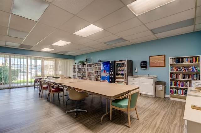 7465 Bay Island Dr S Unit 213, South Pasadena, FL 33707 - dining space with light wood-style floors, beverage cooler, and a drop ceiling
