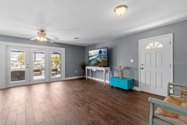 5051 Bonito Dr, New Port Richey, FL 34652 - living room with ceiling fan, baseboards, wood finished floors, and a textured ceiling